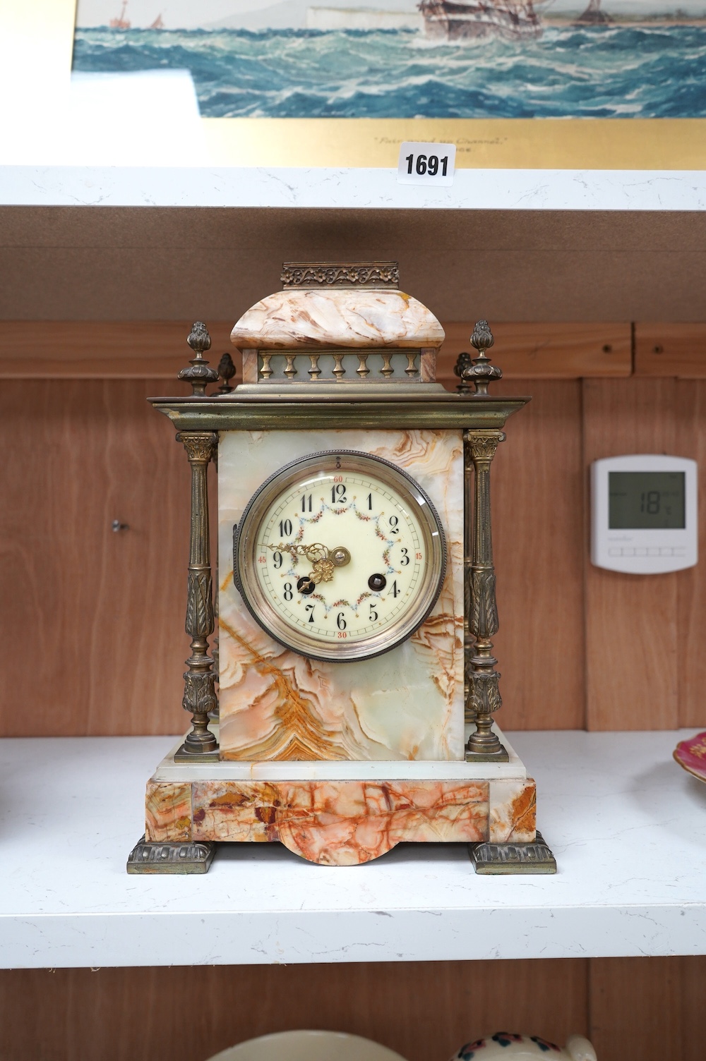 An early 20th century marble and onyx mantel clock with enamel dial with pendulum, no key, 32cm high. Condition - fair, untested